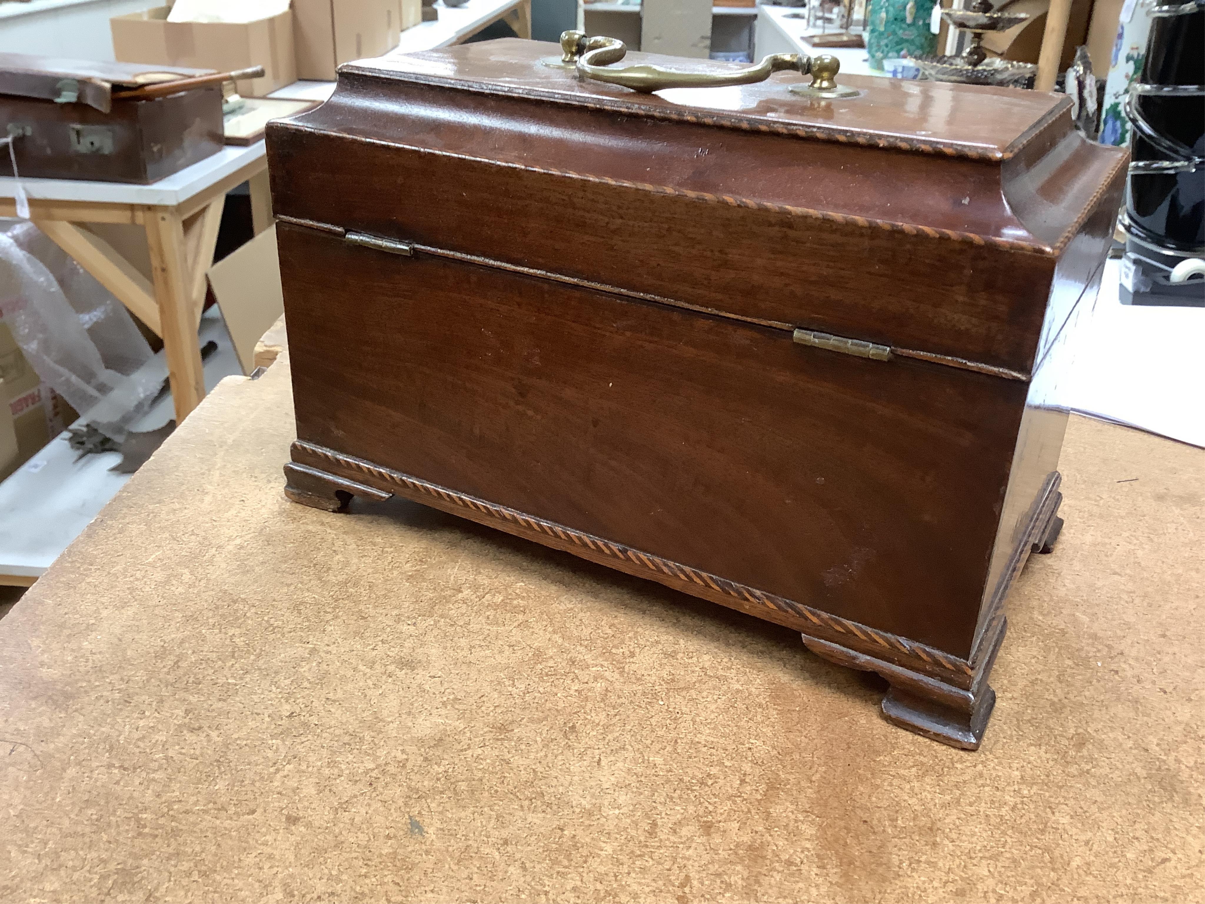 A George III mahogany tea caddy, containing tinned metal canisters, 25cm wide